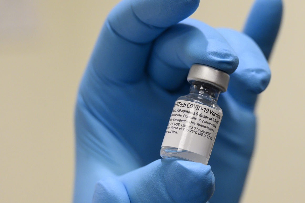 Army Spc. Angel Laureano holds a vial of the COVID-19 vaccine, Walter Reed National Military Medical Center, Bethesda, Md., Dec. 14, 2020. (DoD photo by Lisa Ferdinando)