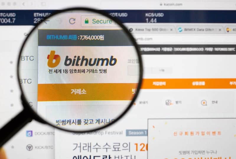 Magnifying glass above Bithumb website