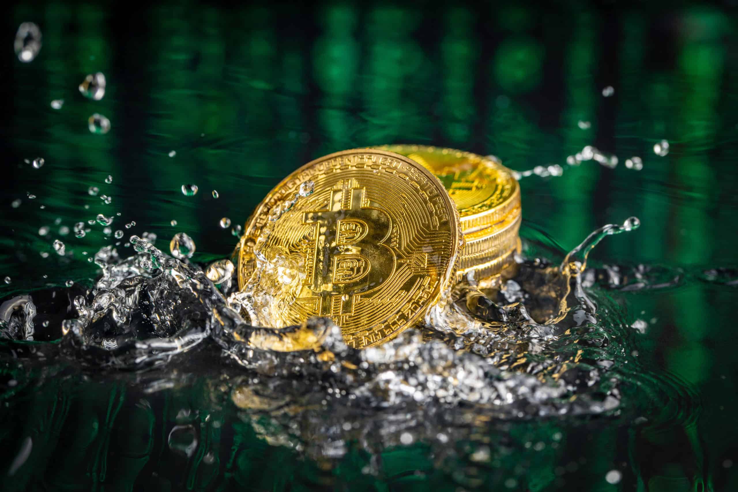 gold bitcoin coin falling to water bitcoin and wat AHYS9F8 scaled