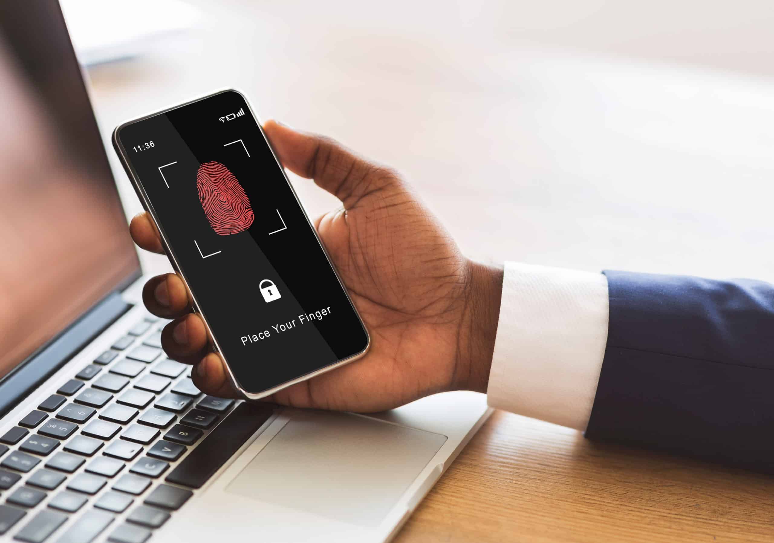 man holding phone with fingerprint scanning smartp CRL2539 scaled