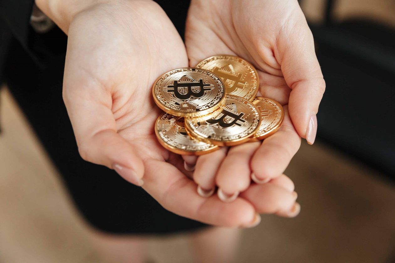 Business lady showing her bitcoins in hands.