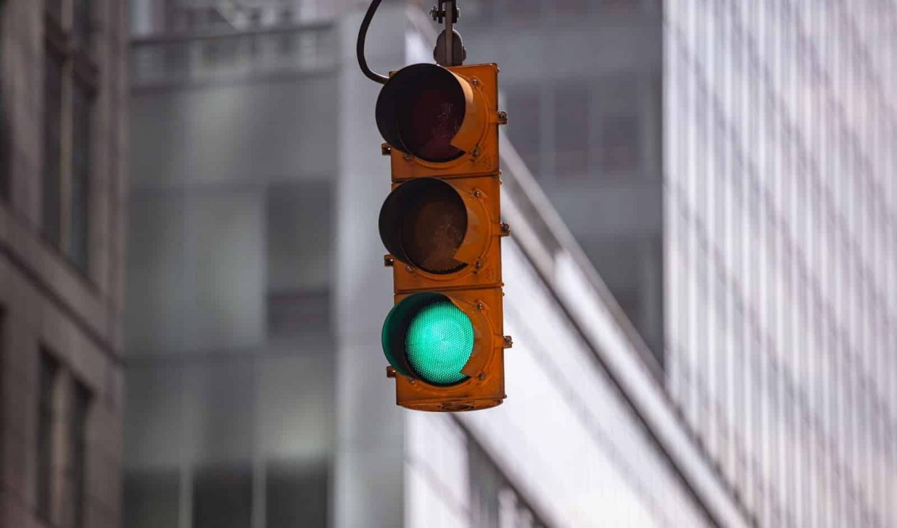 green traffic lights for cars blur office building Q68SKBZ