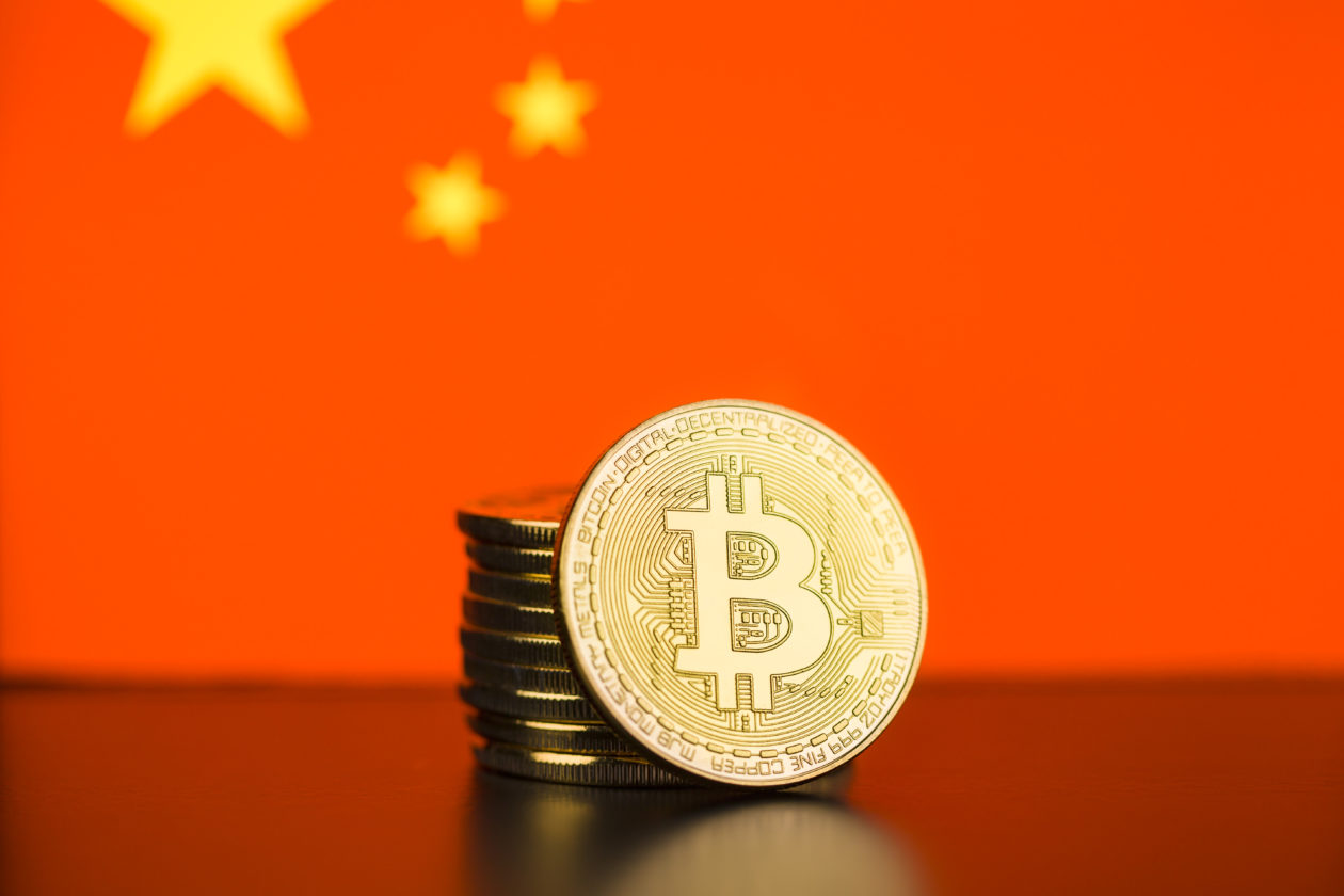 Golden bitcoin in front of Chinese flag, now crypto miners are scrambling to leave