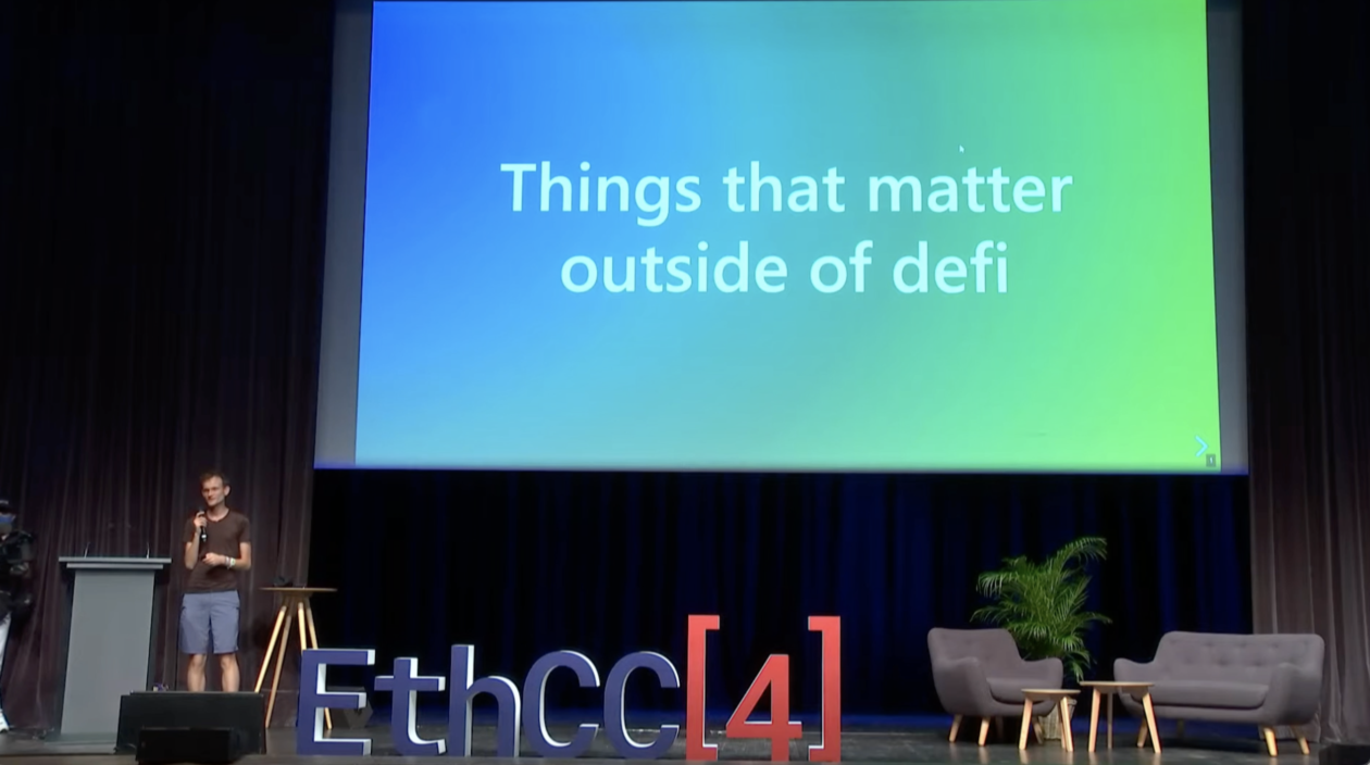 Vitalik Buterin on the main stage of EthCC Paris, with a wide screen saying "Things that matter outside of defi" behind him | Vitalik Buterin talks going beyond DeFi at EthCC4 Paris