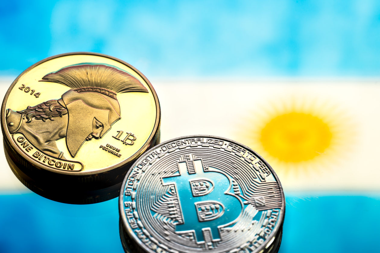 coins Bitcoin, against the background of Argentina flag, concept of virtual money, close-up. Conceptual image of digital crypto currency.