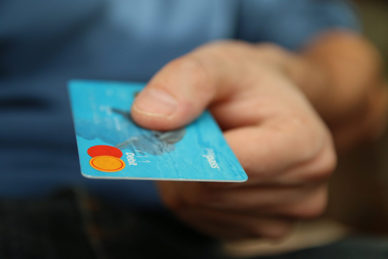 Man holding a Mastercard credit card