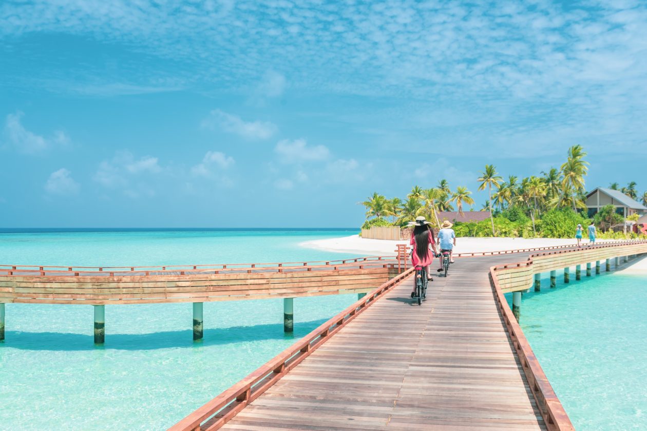 People riding a bike on a bridge in the Bahamas