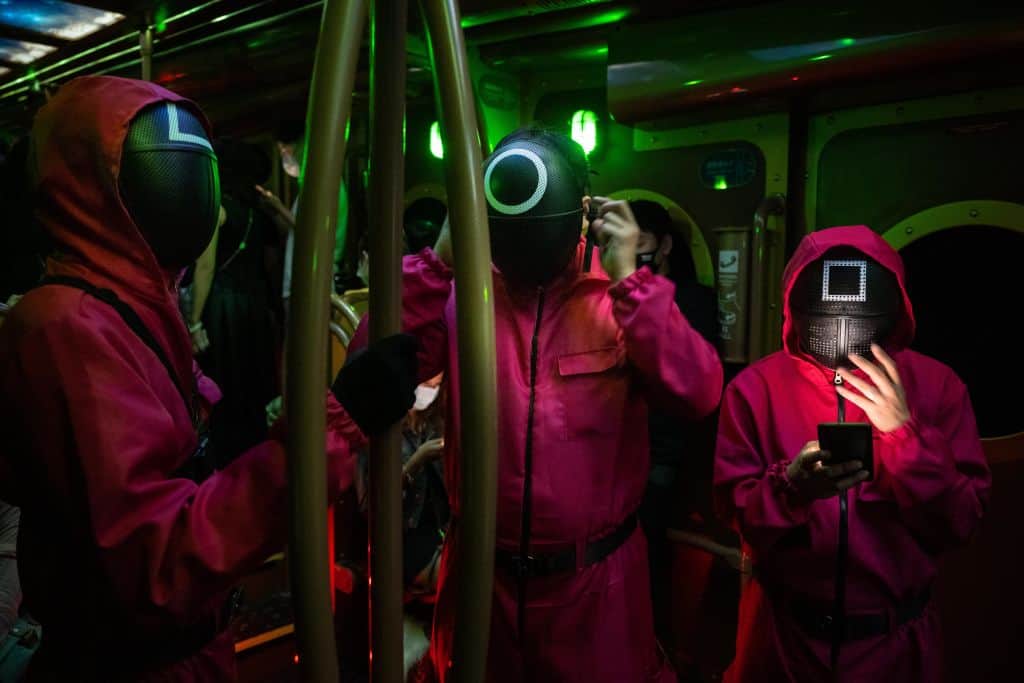 People in the subway dressed as characters from Netflix series Squid Game