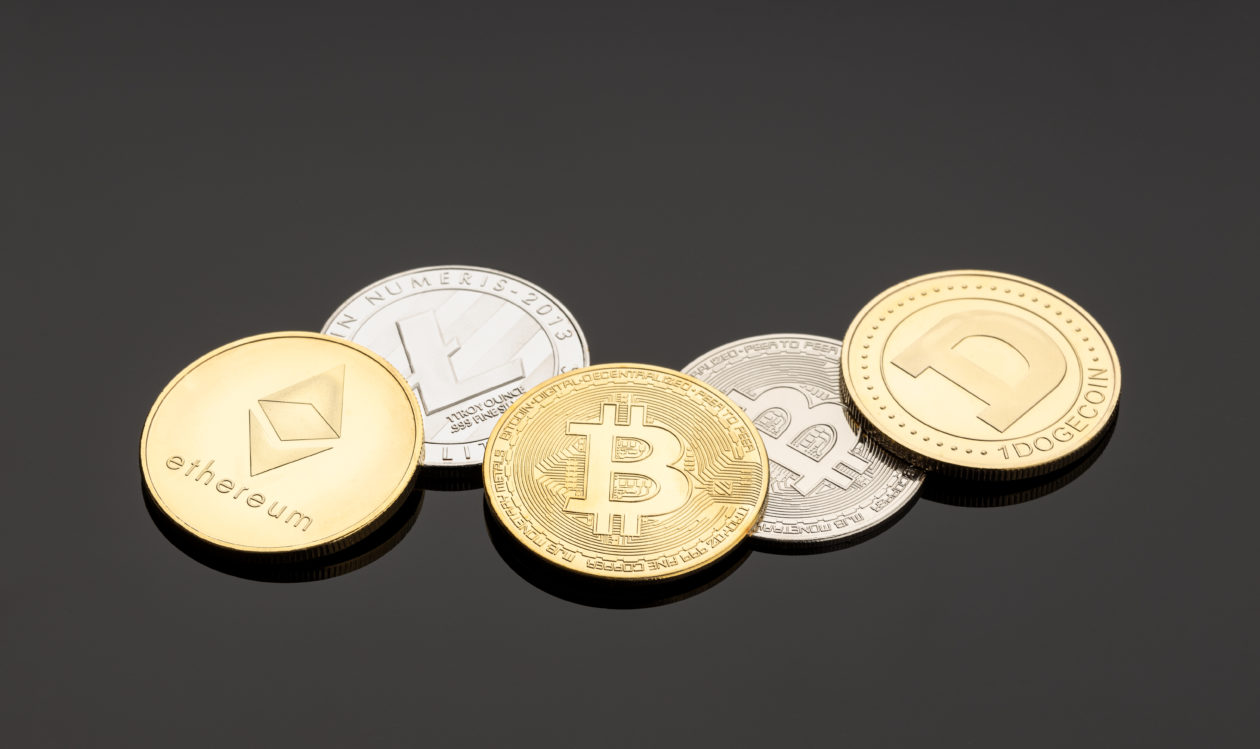 Cryptocurrency coins on dark background, what is driving the digital asset surge in 2021.