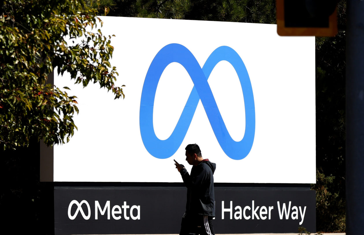Pedestrian walks past new Meta logo at Facebook headquarters | Meta says South Korea is befitting for metaverse business.