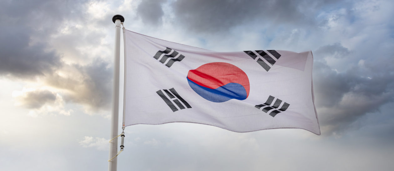 South Korea flag waving against cloudy sky | South Korea cryptocurrency exchanges update