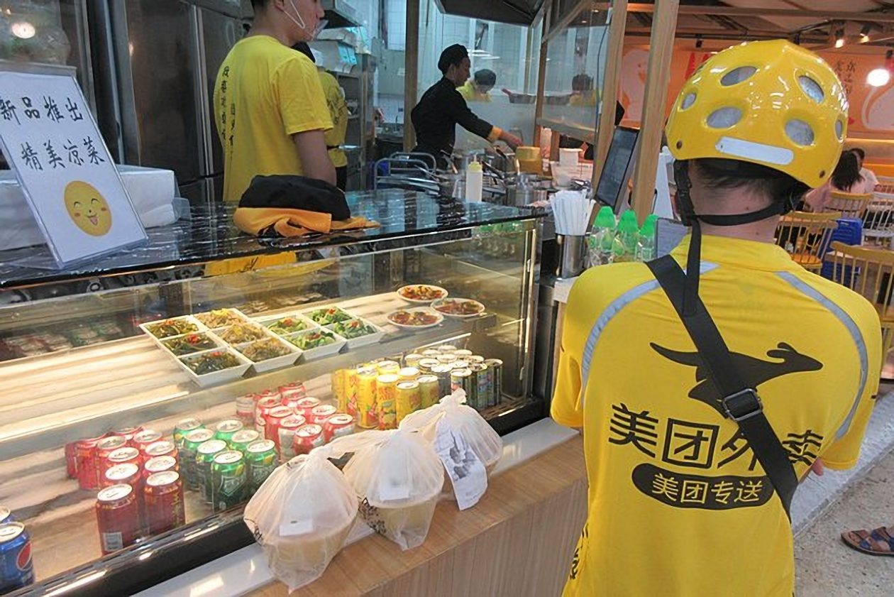 A Meituan food delivery worker wearing yellow uniform, China's largest food delivery platform Meituan accepts e-CNY payment
