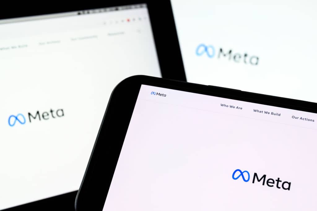 In this photo illustration, three screens display the splash page for the Meta page on the facebook website on October 29, 2021 in London, England. The Facebook company, which owns Facebook, Whatsapp and Instagram, has announced that it is rebranding, changing it's name to "Meta".