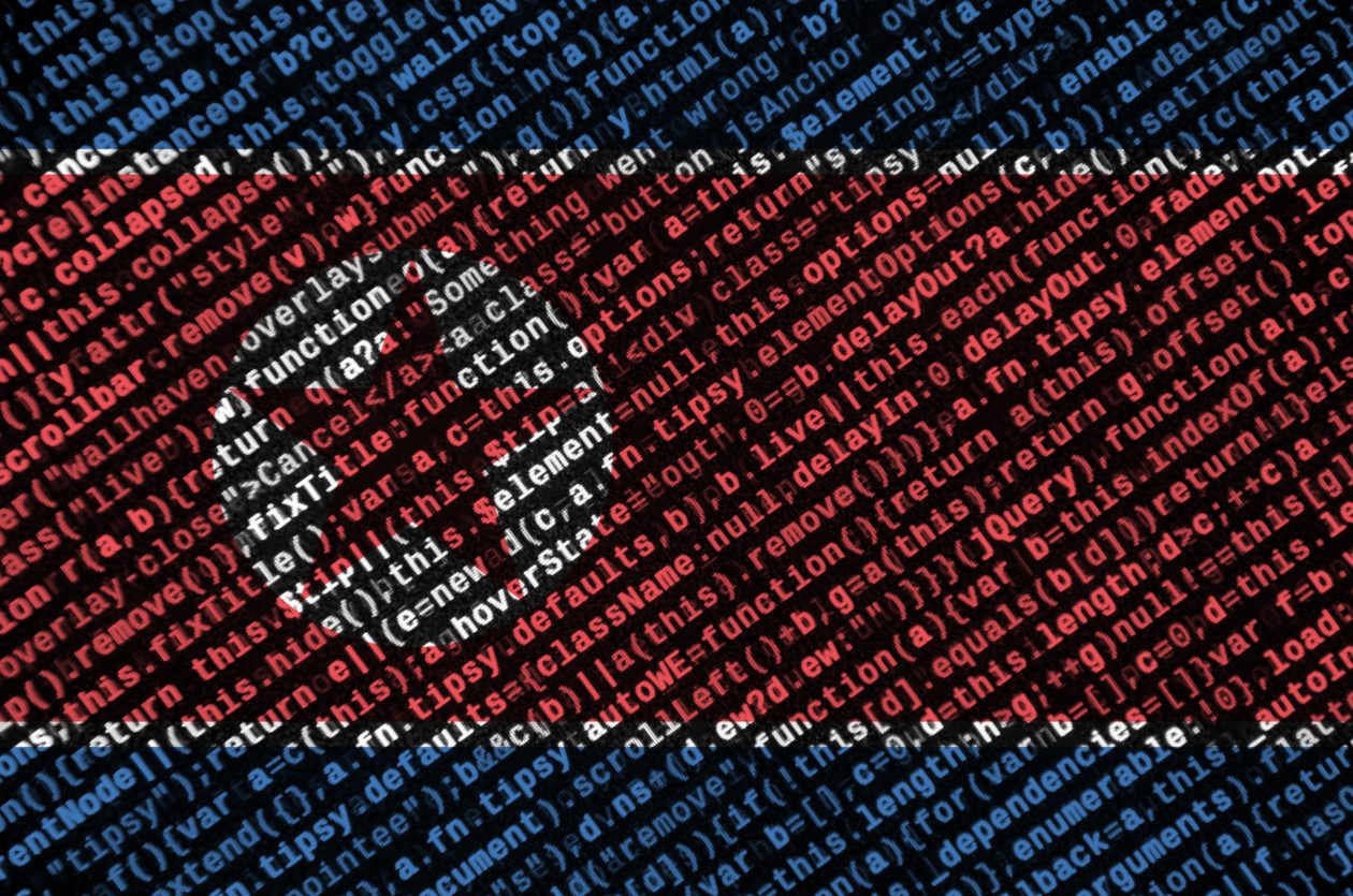 North Korea flag is depicted on the screen with the program code. The concept of modern technology and site development | North Korea hacked US$400M of crypto in 2021, says Chainalysis