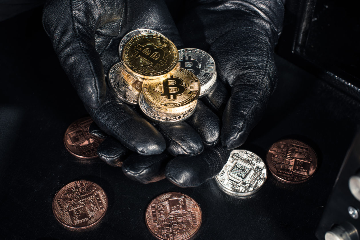 stack of bitcoin in hands of thief wearing gloves 2021 08 29 21 23 31 utc 1