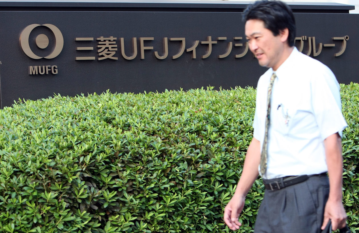Man walking past Mitsubishi UFJ headquarters | Japan’s Mitsubishi UFJ to issue yen-pegged stablecoin: report