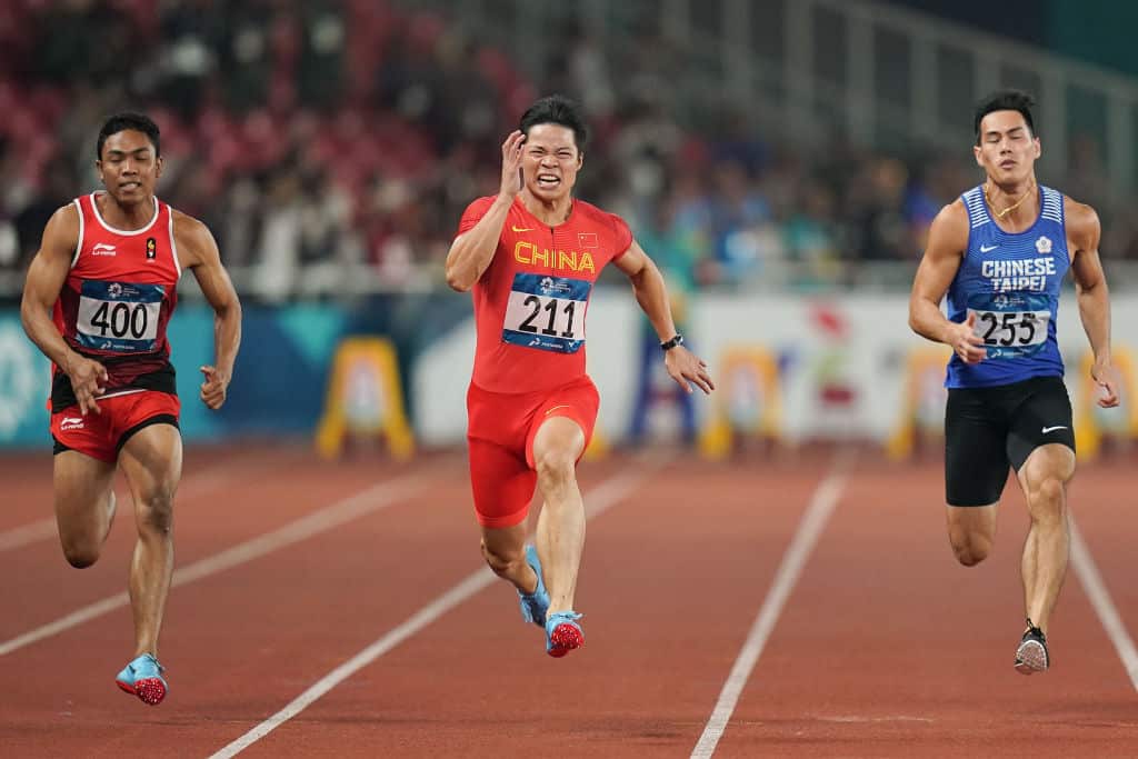 (L-R) Indonesia's Muhammad Zohri, Su Bingtian of China and Taiwan's Yang Chunhan compete in the final of the men's 100m athletics event on day eight of the Asian Games on August 26, 2018 in Jakarta, Indonesia.