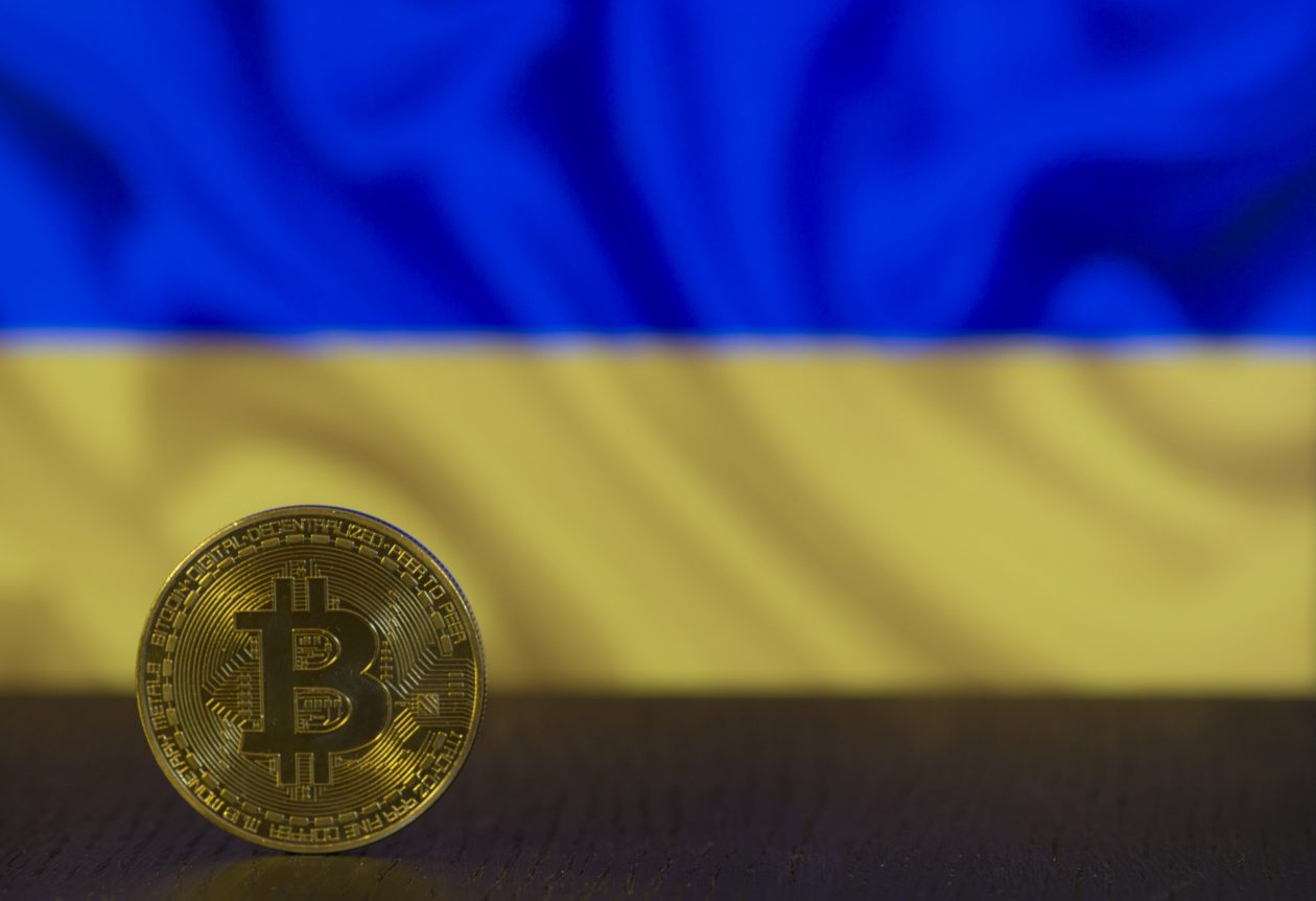 Ukraine flag with physical model of Bitcoin