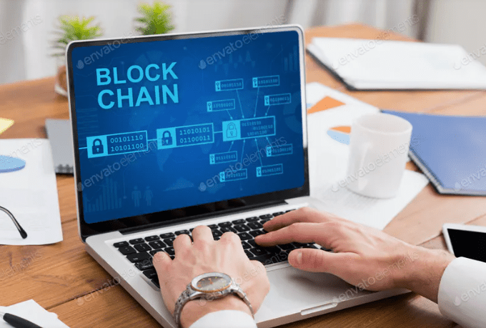 Businessman is programming with technology, using blockchain for online payments and money transactions