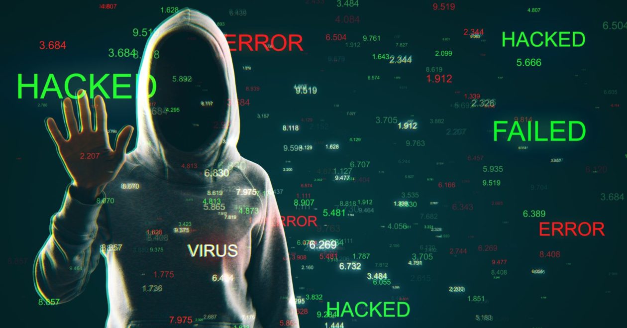 Hooded hacker in front of a digital background