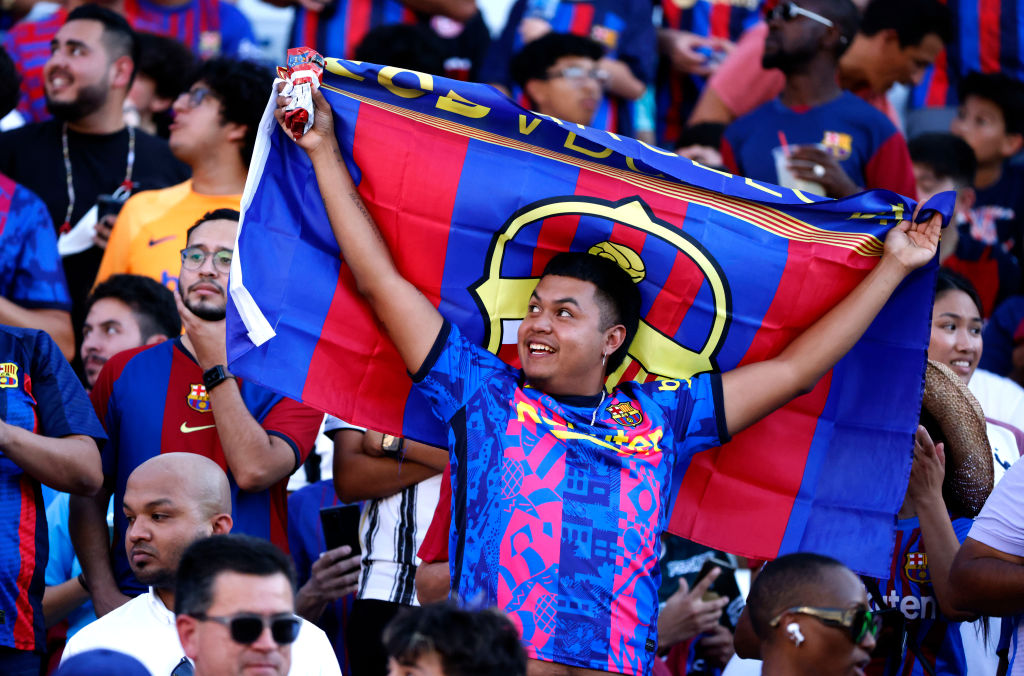Chiliz CHZ jumps as a fan of FC Barcelona waves a flag during an 2022 International Friendly match between FC Barcelona and Juventus at the Cotton Bowl on July 26, 2022 in Dallas, Texas. (