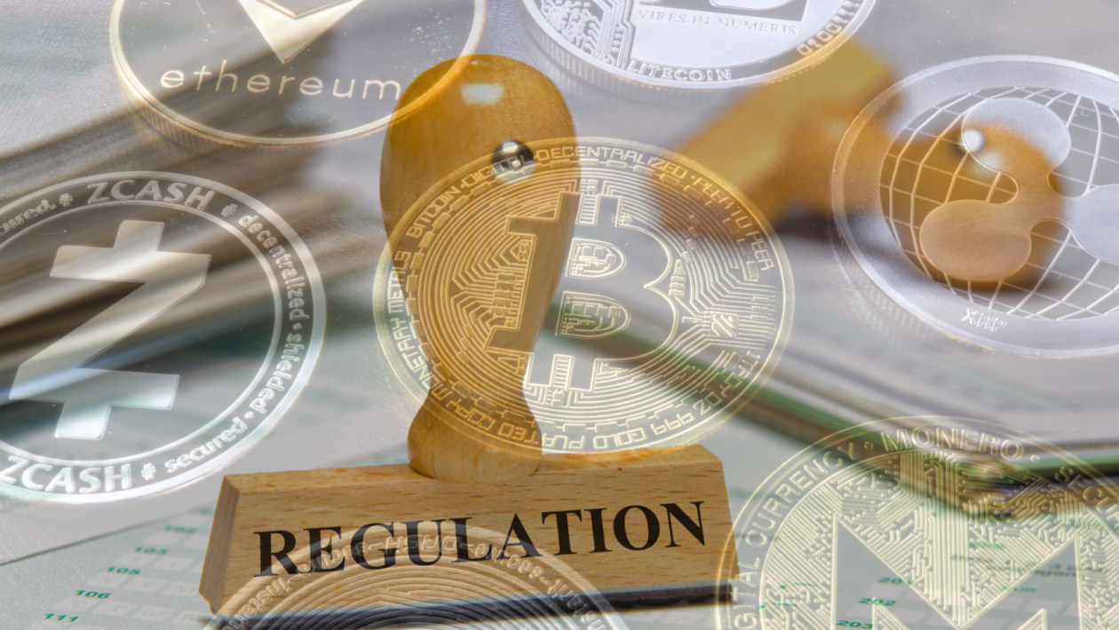 Regulation marked on rubber stamp with various cryptocurrencies in the background
