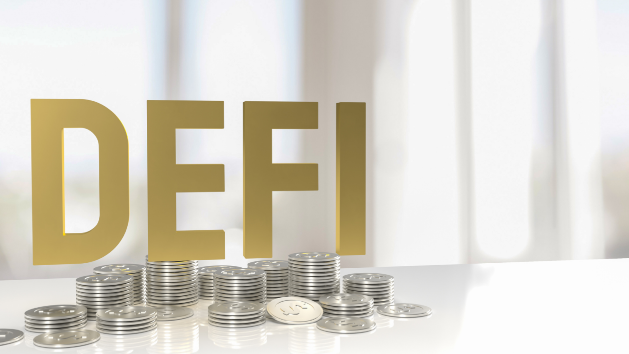 The word DEFI in gold font color with silver coins