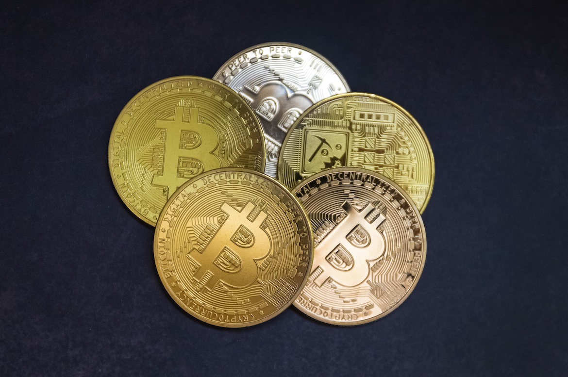 Bitcoin coins on black background, top view