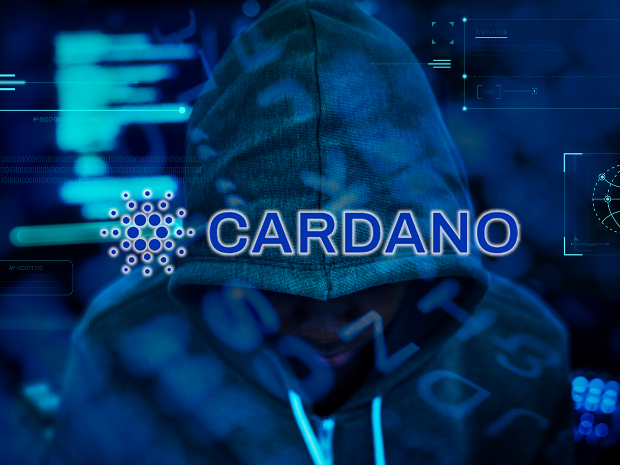 Cardano logo in front of an image of a hacker wearing a hoodie | Cardano users said to be indirectly affected by Nomad’s US$200 mln exploit | Cardano ada, cardano, nomad, cardano nomad, cardano news