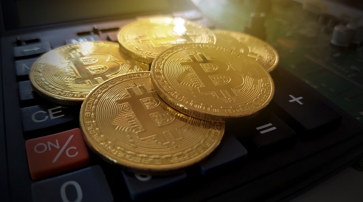 Golden bitcoin digital currency, crypto money on calculator