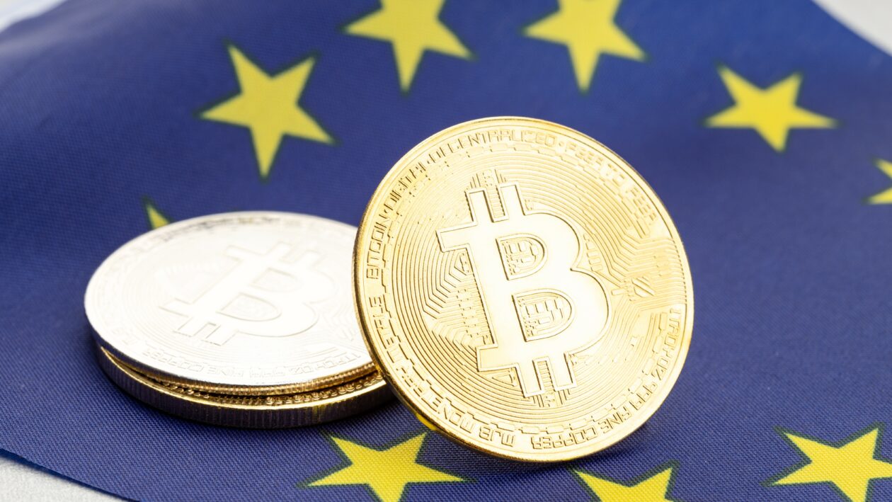 Bitcoin cryptocurrency coins on national flag of European Union. Crypto law regulation concept