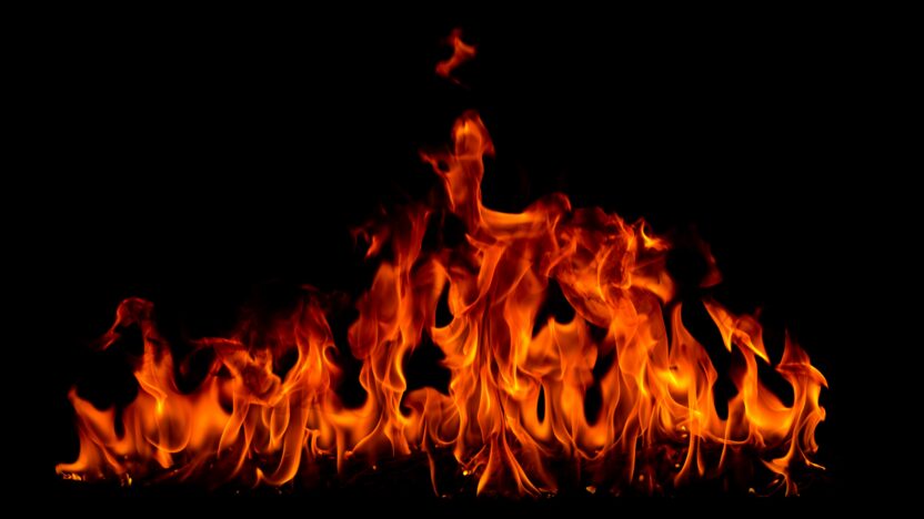 Fire flames with smoke on black background, Burning red hot sparks rise