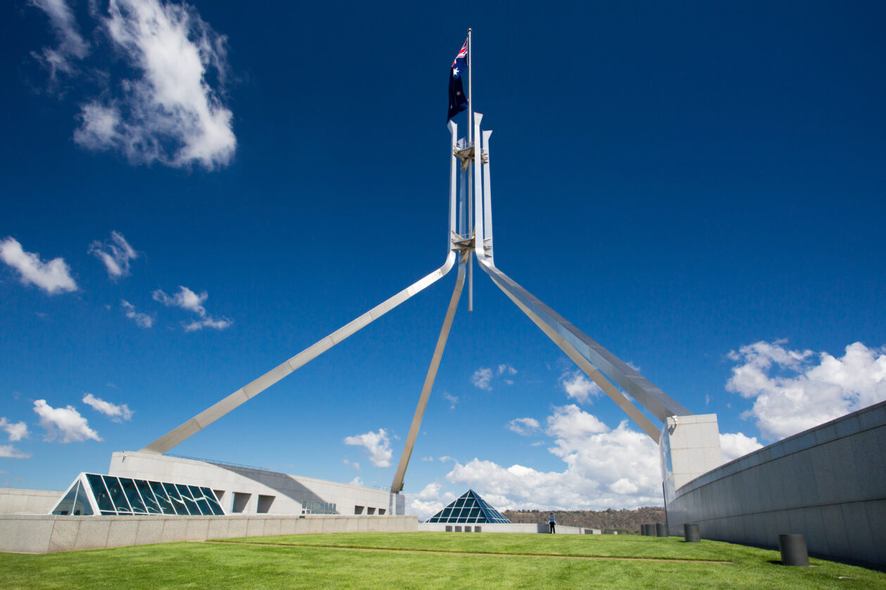 Parliament of Australia against blue sky. Australian 2022 budget confirms digital assets will not be taxed as foreign currency