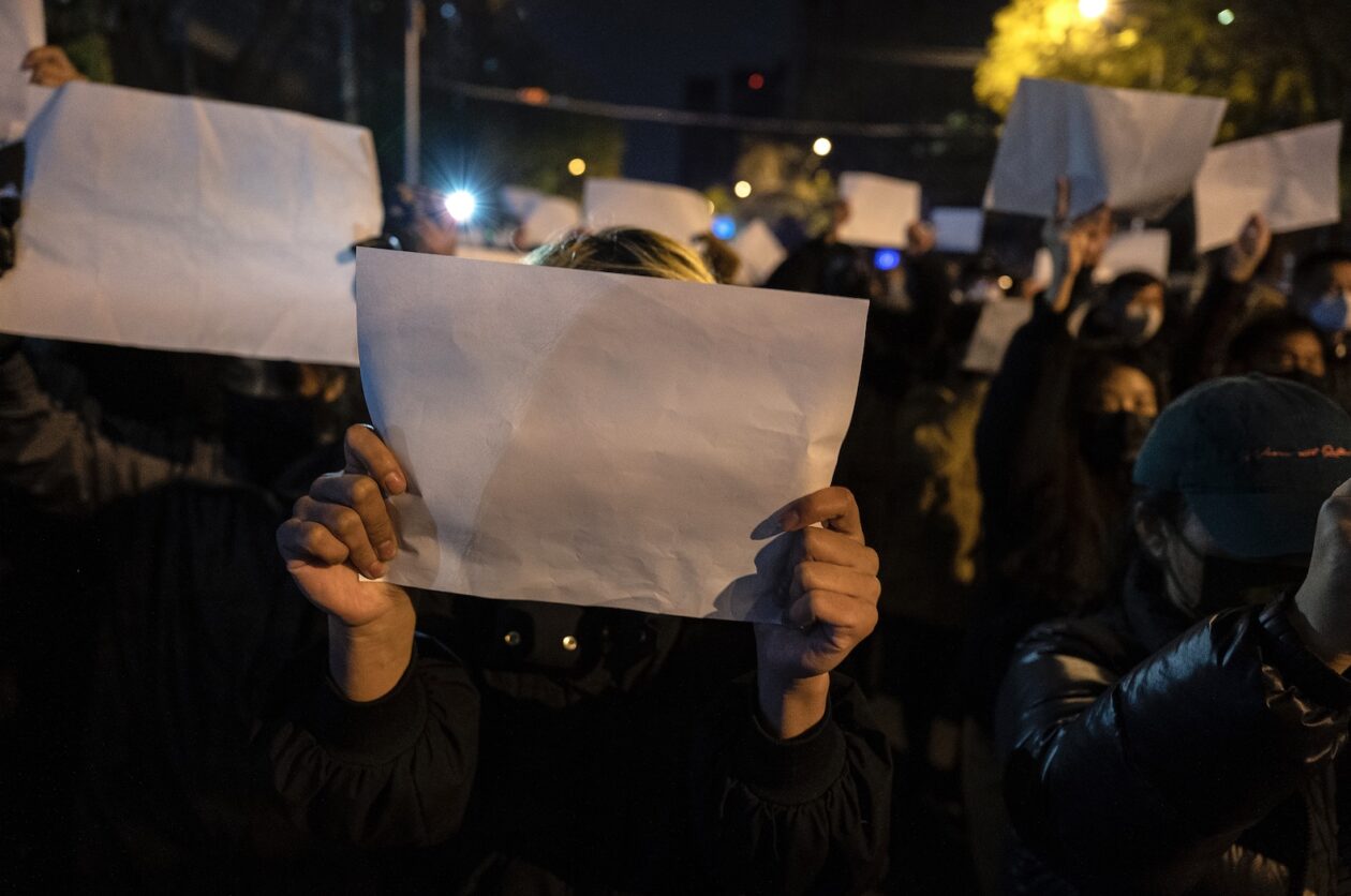 Protesters hold up a white piece of paper against censorship as they march during a protest against Chinas strict zero COVID measures on Nov. 27 in Beijing.