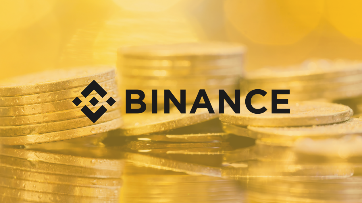 Binance logo with stacked golen coins in the background