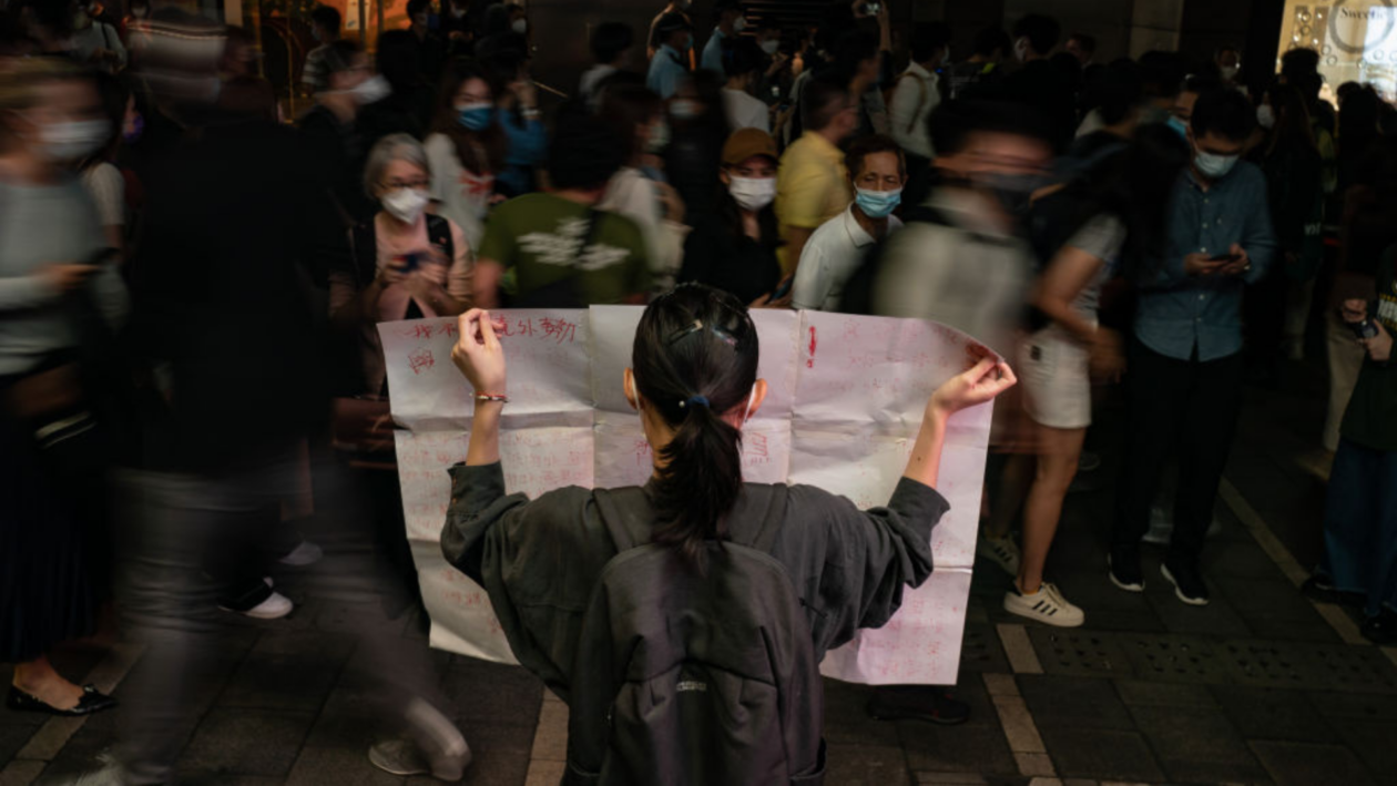 Grayscale holdings questioned amid crypto investment giant’s silence 4 Woman holding a blank paper in crowded street amid China's anti-Covid protest