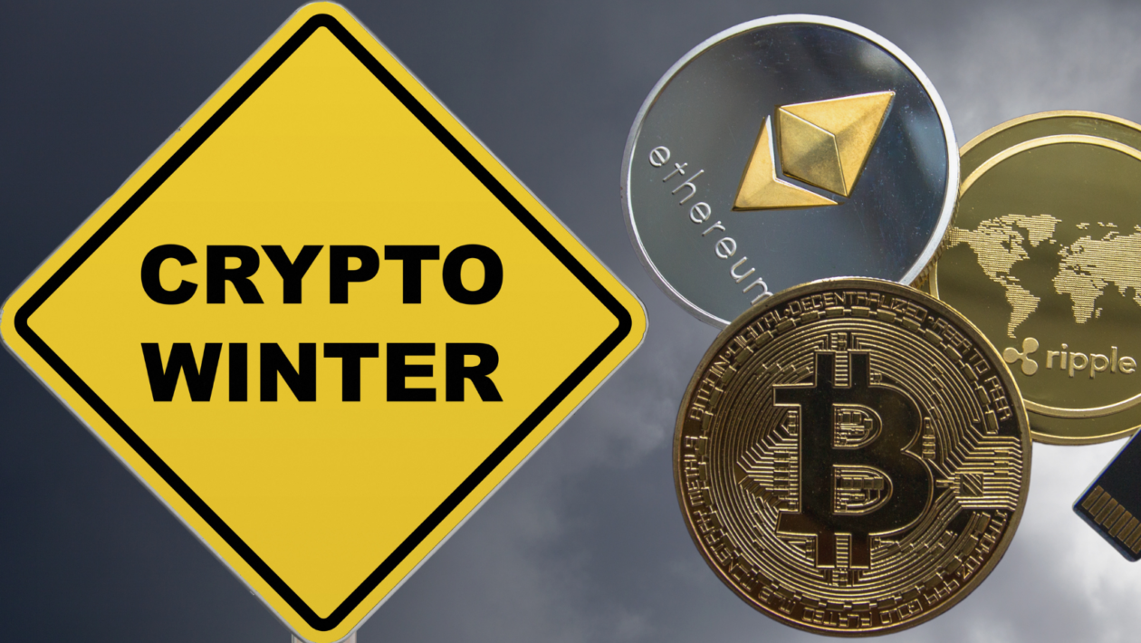 yellow crossing sign with words "crypto winter" and crypto coins