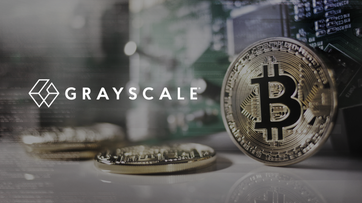 Grayscale logo in front of physical models of Bitcoin