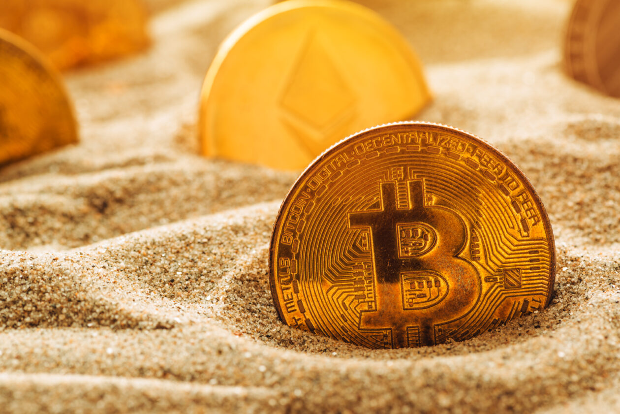 Bitcoin in the sand. | Markets: Bitcoin dips back below US$17,000, Ether falls, Dogecoin leads losers list