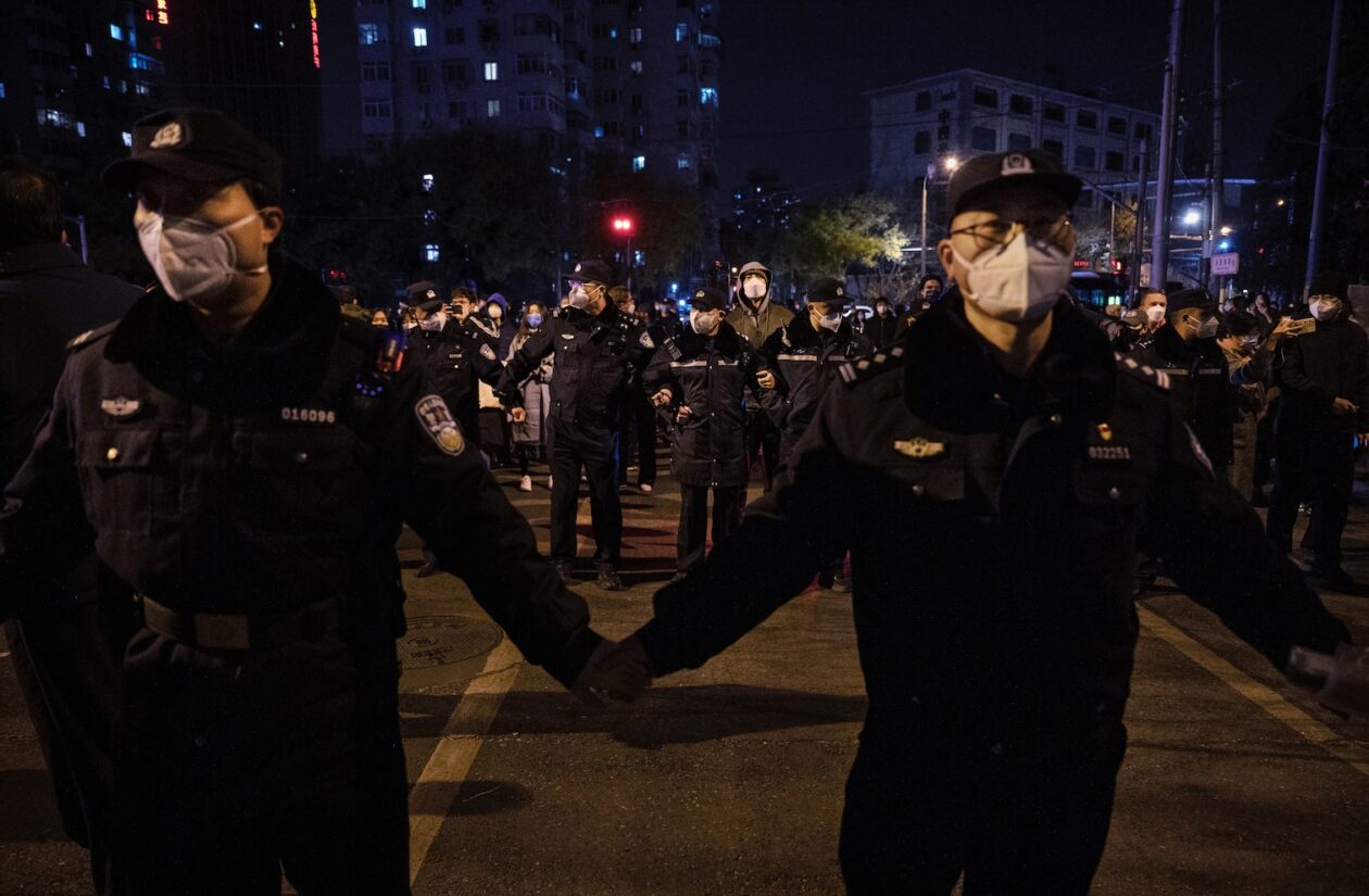 Police form a cordon during a protest against China's strict zero-Covid measures on November 27 in Beijing, China. Image: Kevin Frayer/Getty Images