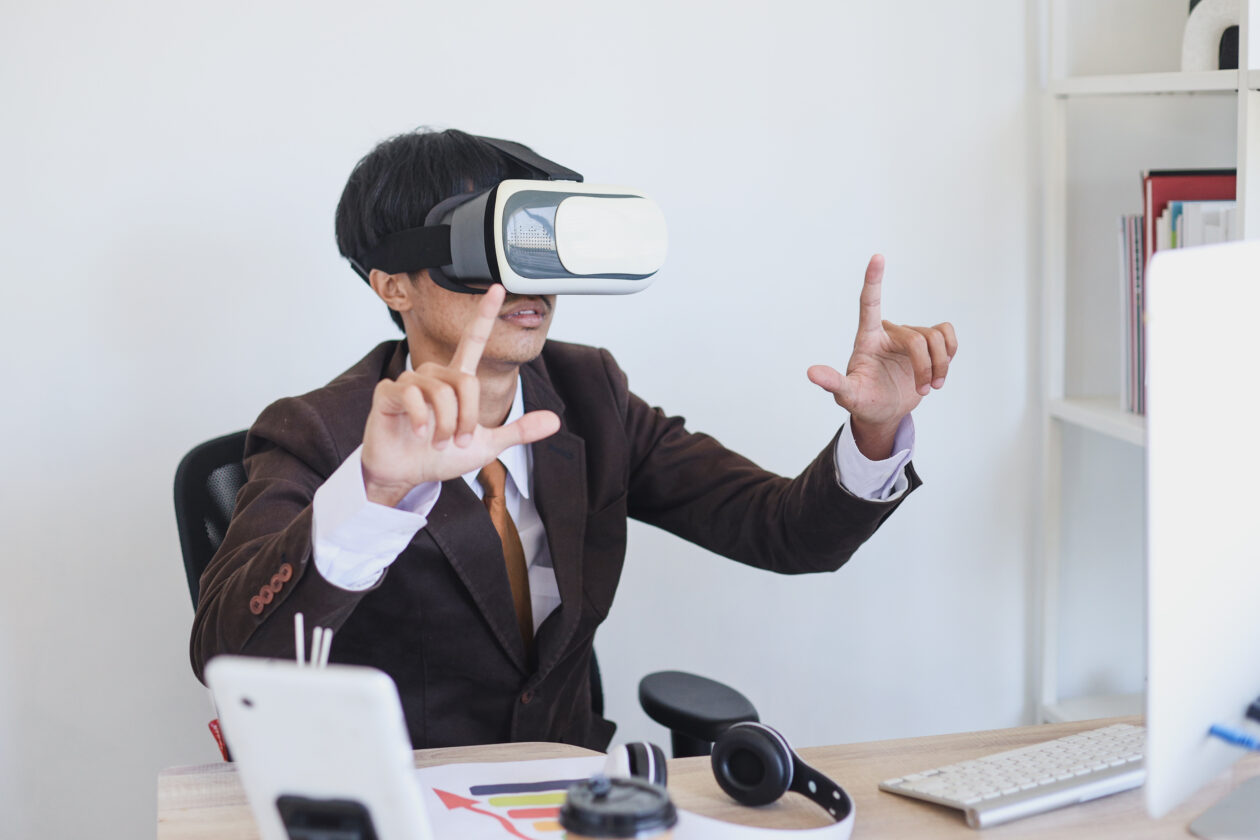 man wearing vr goggles mimes square at desk | S.Korea’s energy conglomerate builds US$84M metaverse fund | south korea metaverse, metaverse fund, daesung