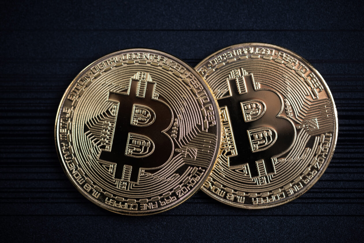 Two Bitcoin on a black background.