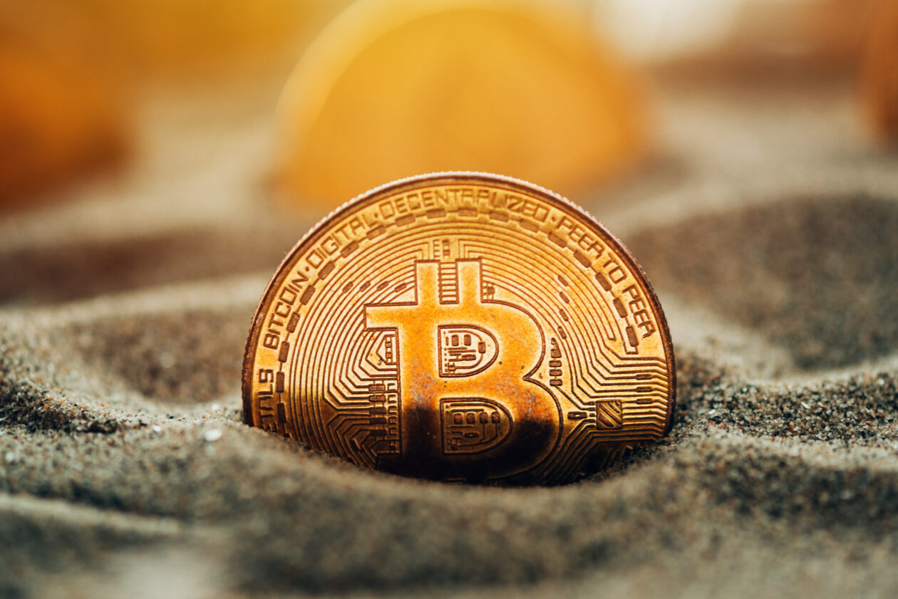 Bitcoins sitting in sand. | Markets: Bitcoin, Ether little changed after weekend surge; Solana, XRP give back some gains.