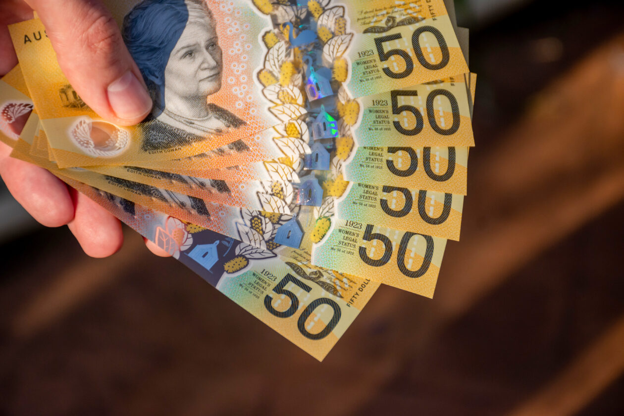 Hands holding australian dollars 50 banknotes.