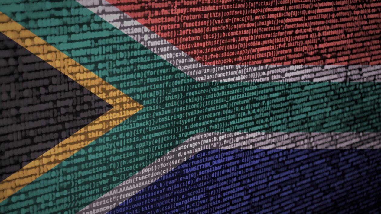 South Africa flag is depicted on the screen with the program code. The concept of modern technology and site development.