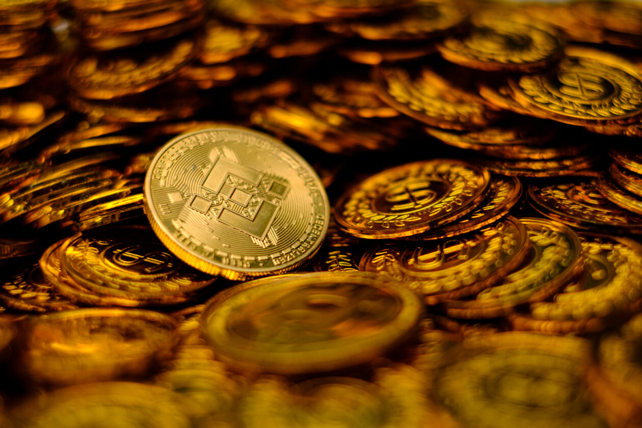BNB among pile of gold coins. | Markets: Bitcoin rises amid market jitters as Paxos stablecoin issuer next regulator target after Kraken clampdown
