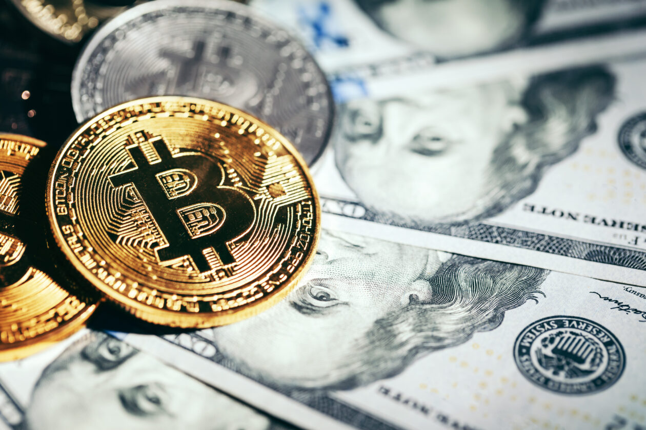 Bitcoins sitting on top of U.S. cash. | Markets: Bitcoin falls below US$23,000, Ether drops as crypto market follows equities lower