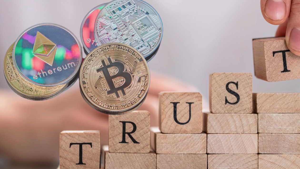 wooden block that spells trust with crypto coins