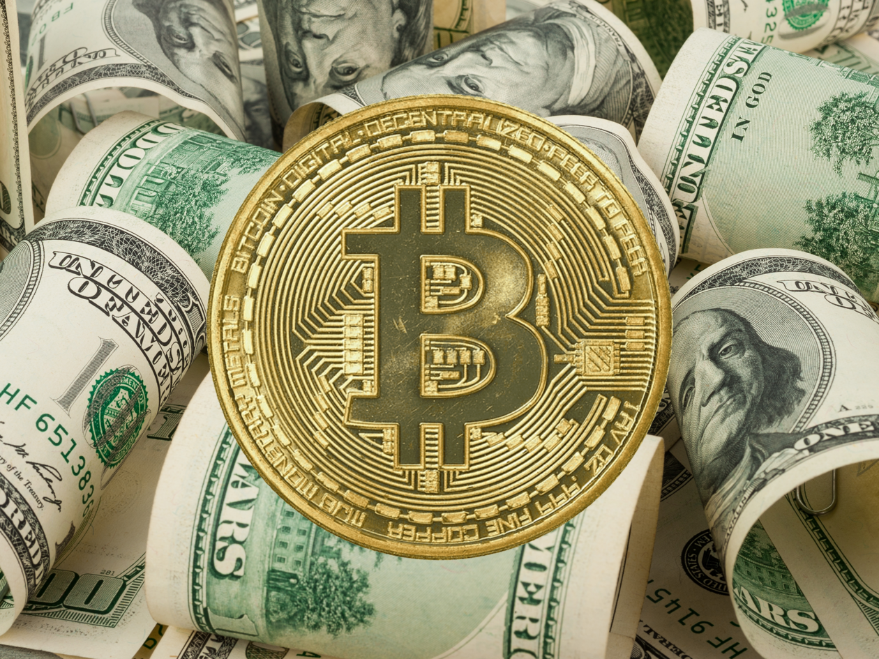 bitcoin gold token and dollar bills | Markets: Bitcoin dips to US$23,500; Ether inches up, other top 10 cryptocurrencies mixed | bitcoin price today, bitcoin news, ether price today, ether news, apple earnings, amazon earnings, alphabet earnings, dogecoin, elon musk