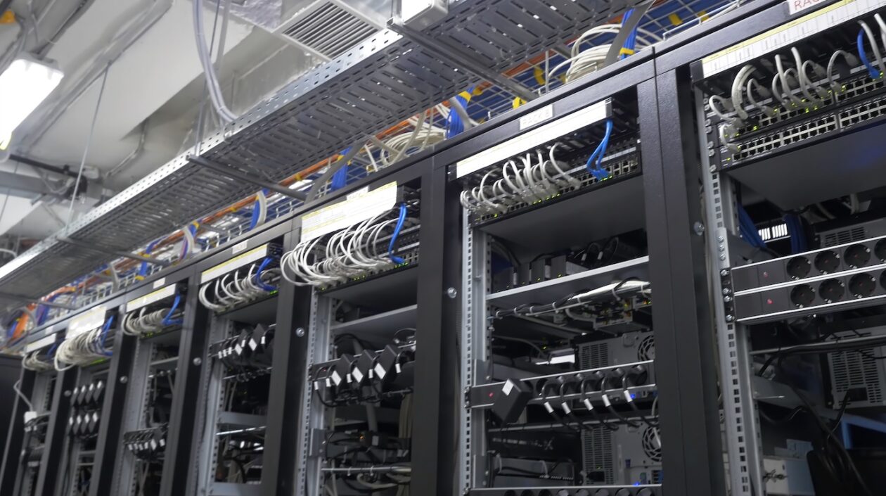 Row of bitcoin miners set up on the wired shelfs